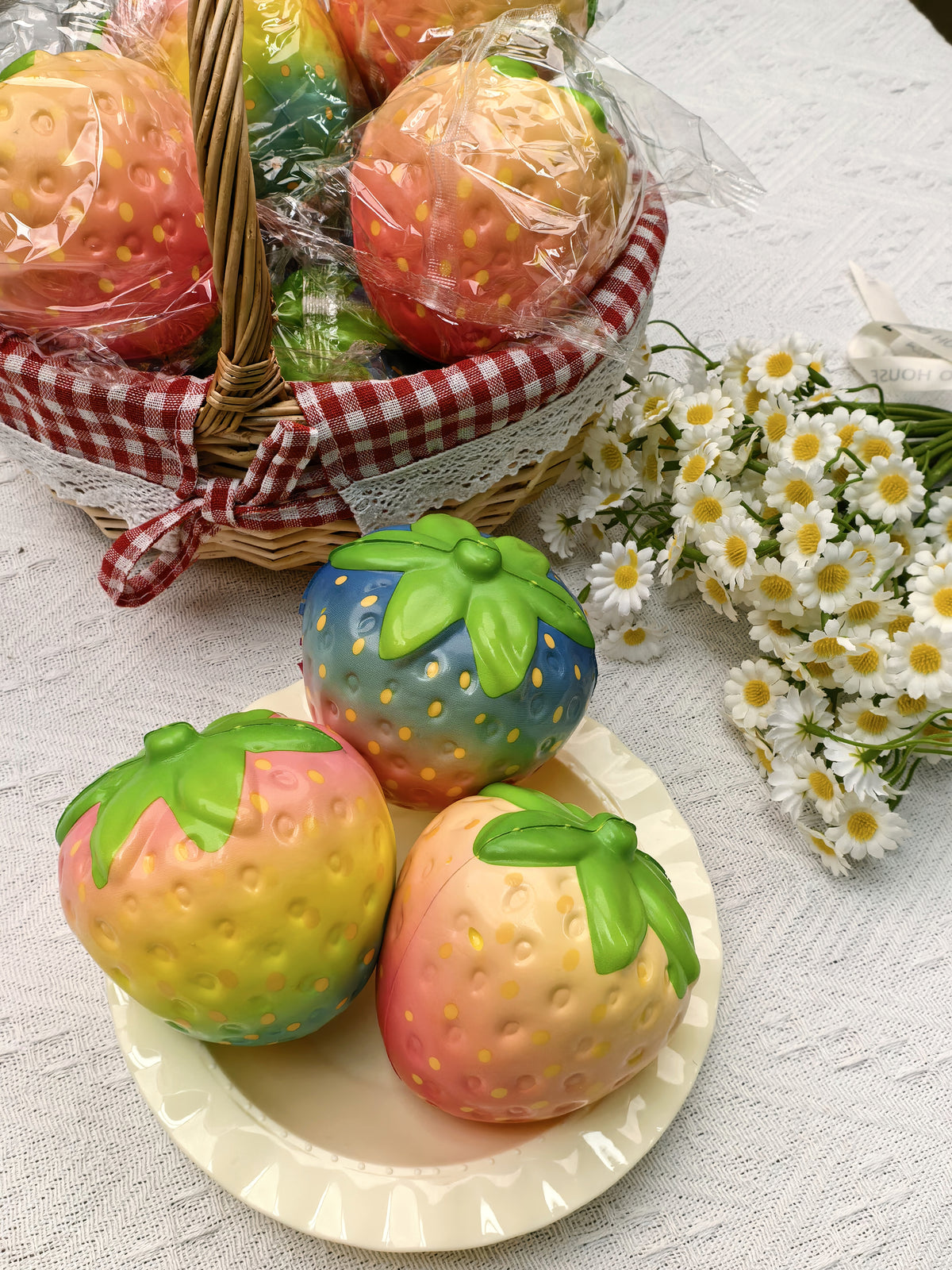 Assorted colorful strawberry squishies in a styled display; choose Single or 12-Piece Box