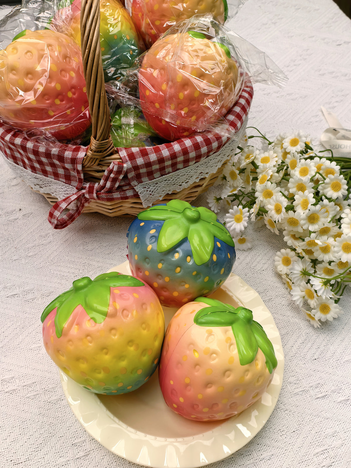 Assorted colorful strawberry squishies in a styled display; choose Single or 12-Piece Box