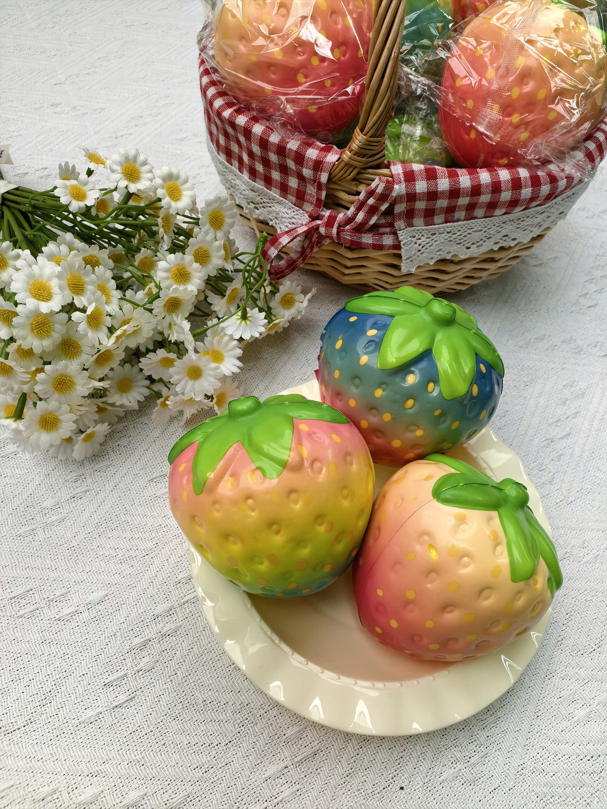 Assorted colorful strawberry squishies in a styled display; choose Single or 12-Piece Box