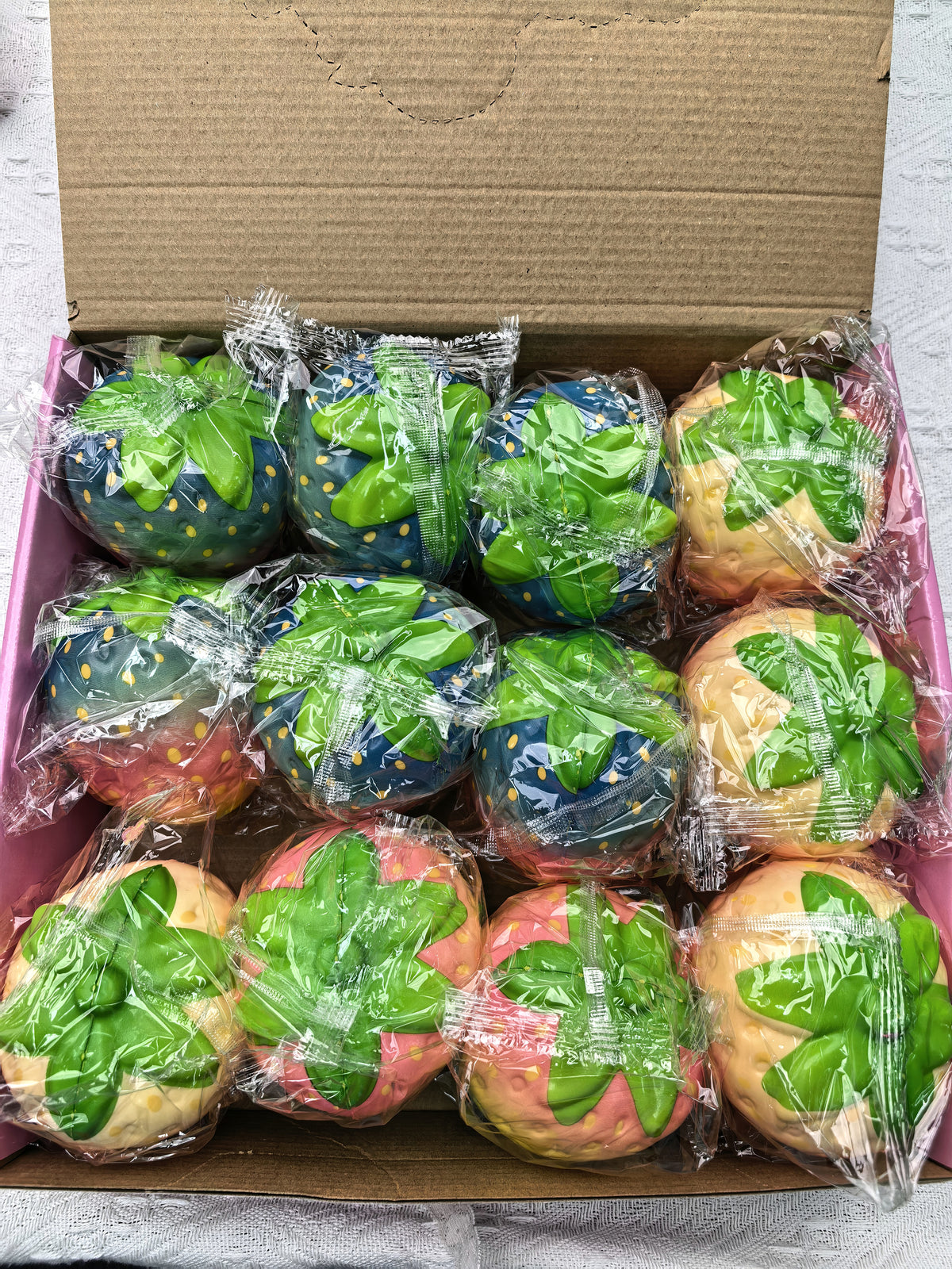 12-piece box of individually wrapped colorful strawberry squishies