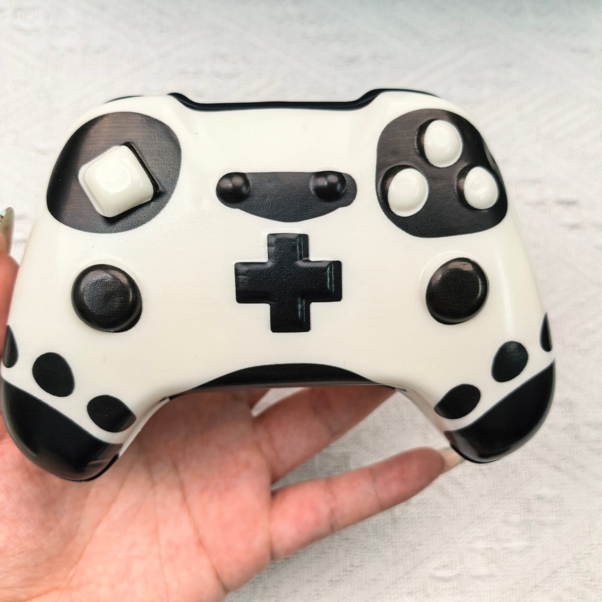 Hand-held black and white controller squishy